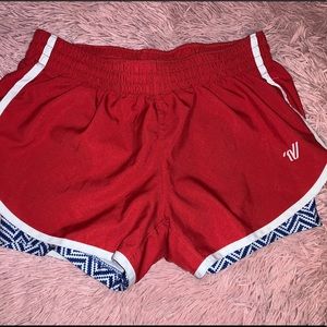 Red varsity track shorts